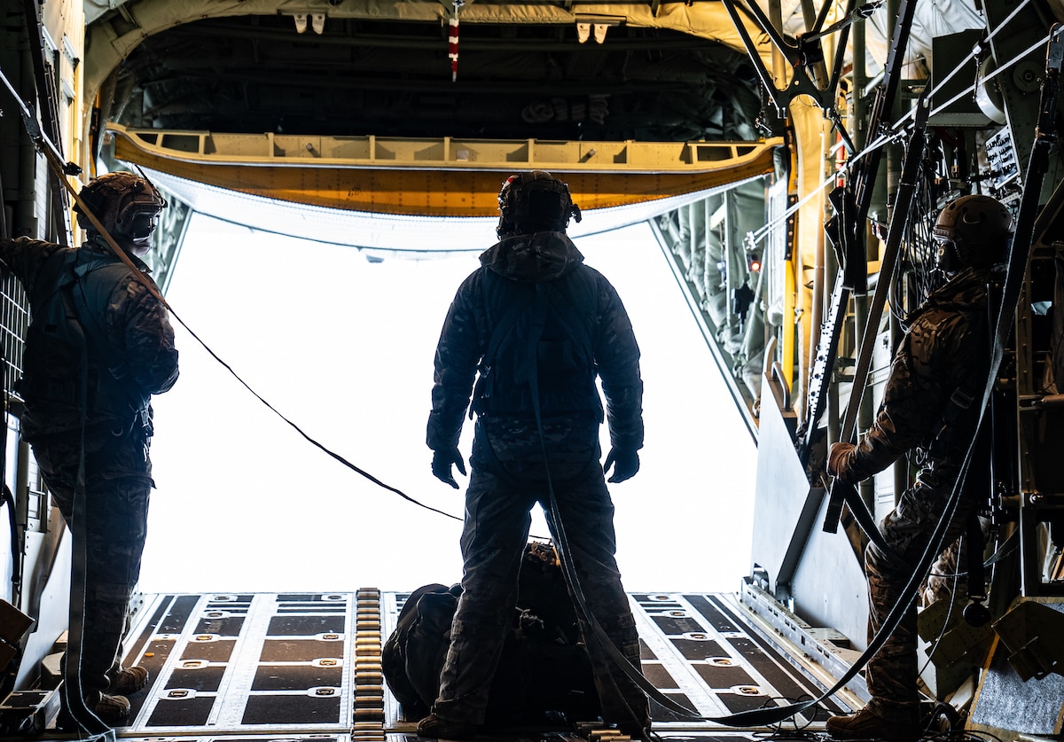 Service member preparing to jump from an airplane.