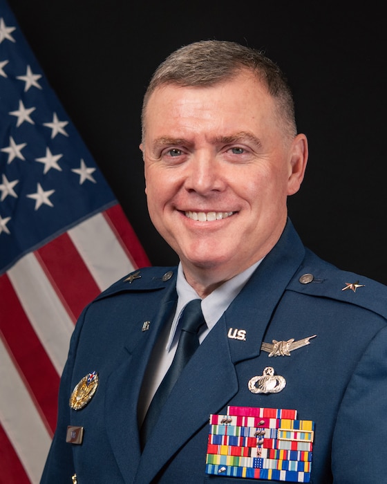White male in dress blues USAF uniform, one star is a Brig Gen