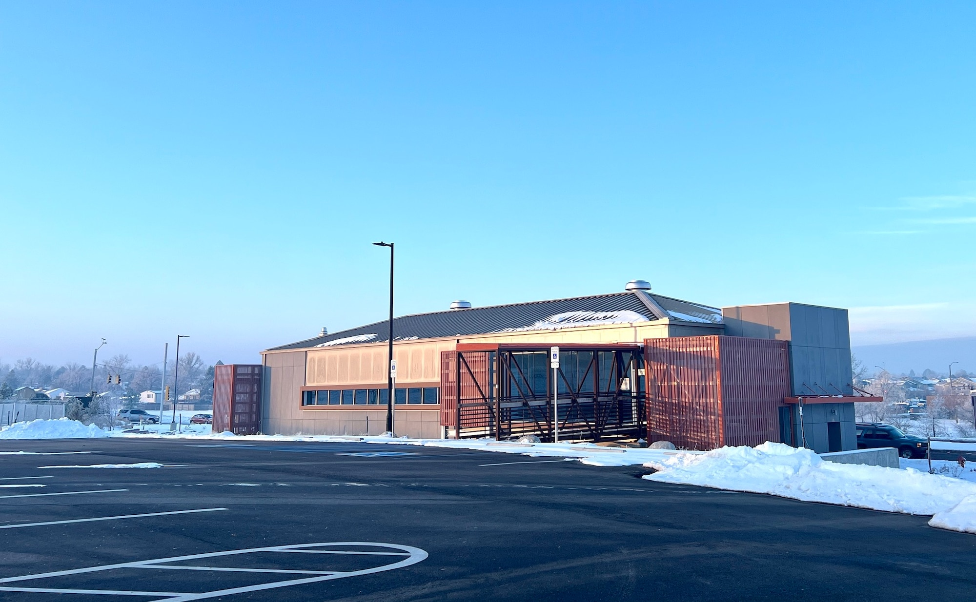 building with snow in the parking lot