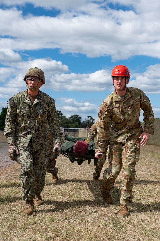 Joint Task Force-Bravo and U.S. Navy Expeditionary Medical Facility 150 Alpha, Camp Pendleton, California, members carry a dummy patient during an air enroute care training at Soto Cano Air Base, Honduras, February 5, 2025. During the three day training members learned how to assess, care for and safely load a patient into a helicopter in case of a medical evacuation. (U.S. Air Force photo by Staff Sgt. Tristan Biese)
