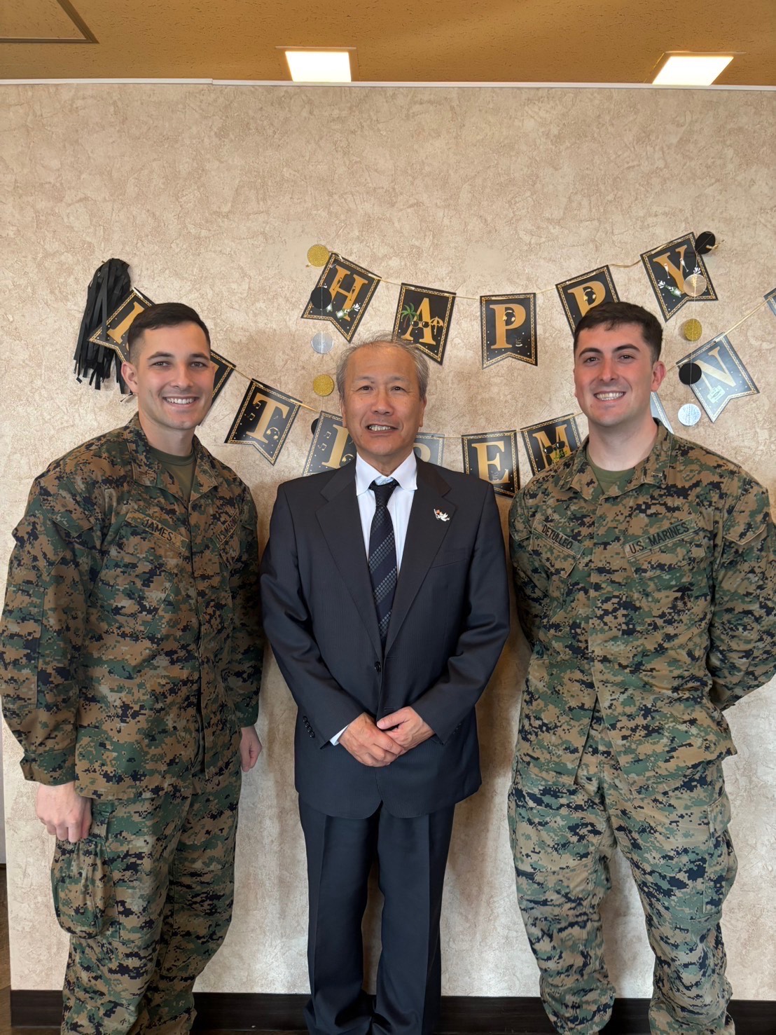 U.S. Marine Corps 1stLt James Detulleo, right, poses for a photo with coworkers during a Master Labor Contract’s retirement ceremony at Marine Corps Air Station Iwakuni, Japan, 2025. (U.S. Marine Corps Courtesy Photo)