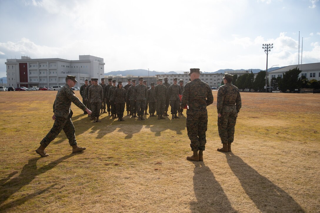 U.S. Marine Corps Lance Cpl. Brandon Champagne, left, an air traffic controller with Headquarters and Headquarters Squadron, Marine Corps Air Station Iwakuni, and a Florida native, marches to the front of formation during a Navy and Marine Corps Achievement Medal award ceremony at MCAS Iwakuni, Japan, Jan. 29, 2025. Lance Cpl. Champagne received the Navy and Marine Corps Achievement Medal for rescuing two individuals trapped in wreckage after a vehicle accident while home on leave. (U.S. Marine Corps photo by Cpl. Colin Thibault)