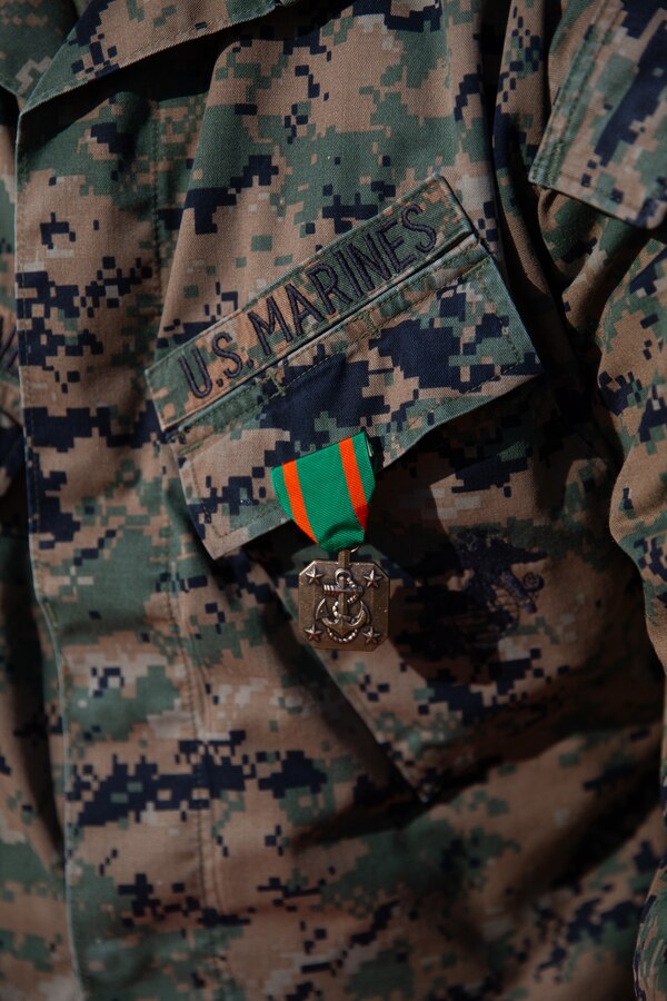 A Navy and Marine Corps Achievement Medal hangs from the breast pocket of U.S. Marine Corps Lance Cpl. Brandon Champagne, an air traffic controller with Headquarters and Headquarters Squadron, Marine Corps Air Station Iwakuni, and a Florida native, during an award ceremony at MCAS Iwakuni, Japan, Jan. 29, 2025. Champagne received the Navy and Marine Corps Achievement Medal for rescuing two individuals trapped in wreckage after a vehicle accident while home on leave. (U.S. Marine Corps photo by Cpl. Colin Thibault)