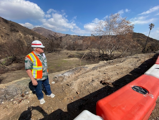 A geotechnical engineer with the U.S. Army Corps of Engineers Los Angeles District assesses the northeast side of an Environmental Protection Agency wildfire debris removal transfer site Feb. 10 near Topanga Canyon in Malibu, California. In addition to modeling predictions for debris flows for an impending rain event this week, hydraulic and geotechnical engineers physically assessed the site to advise EPA on measures to reduce potential risks from impending and future rainstorms.