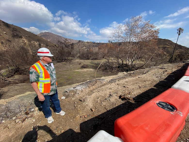 A geotechnical engineer with the U.S. Army Corps of Engineers Los Angeles District assesses the northeast side of an Environmental Protection Agency wildfire debris removal transfer site Feb. 10 near Topanga Canyon in Malibu, California. In addition to modeling predictions for debris flows for an impending rain event this week, hydraulic and geotechnical engineers physically assessed the site to advise EPA on measures to reduce potential risks from impending and future rainstorms.