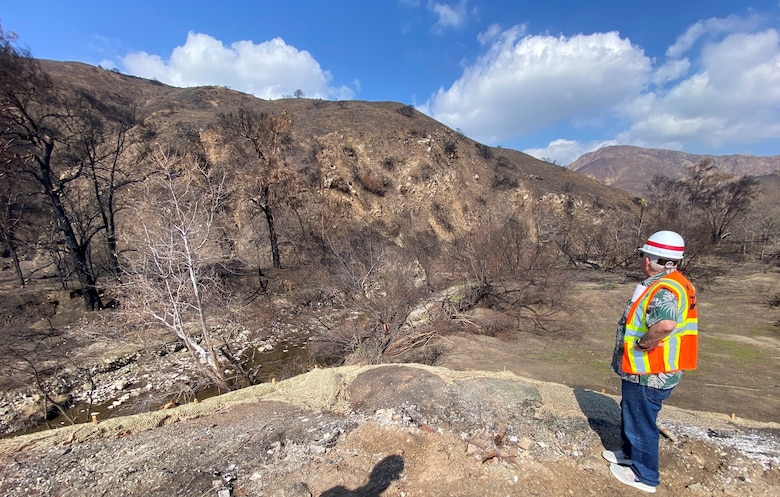A geotechnical engineer with the U.S. Army Corps of Engineers Los Angeles District assesses the northeast side of an Environmental Protection Agency wildfire debris removal transfer site Feb. 10 near Topanga Canyon in Malibu, California. In addition to modeling predictions for debris flows for an impending rain event this week, hydraulic and geotechnical engineers physically assessed the site to advise EPA on measures to reduce potential risks from impending and future rainstorms.