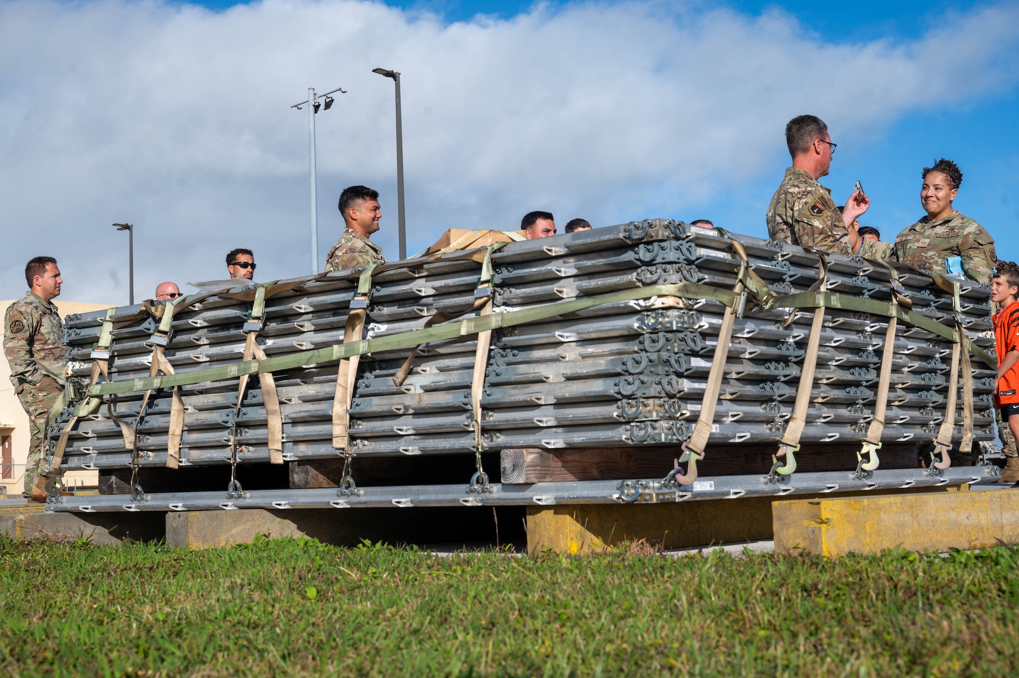 U.S Air Force Brig. Gen. Thomas Palenske, commander of the 36th Wing, coins U.S. Air Force Senior Airman Acadia Haley, special planning technician with the 734th Air Mobility Squadron, on Andersen Air Force Base, Guam, Feb. 10, 2025. The Joint Inspection Demo held by the 734th AMS team includes an example of a correctly built cargo pallet and a cargo pallet with discrepancies from past exercises found during typical processing. (U.S. Air Force Photo by Airman 1st Class Allon Lapaix)