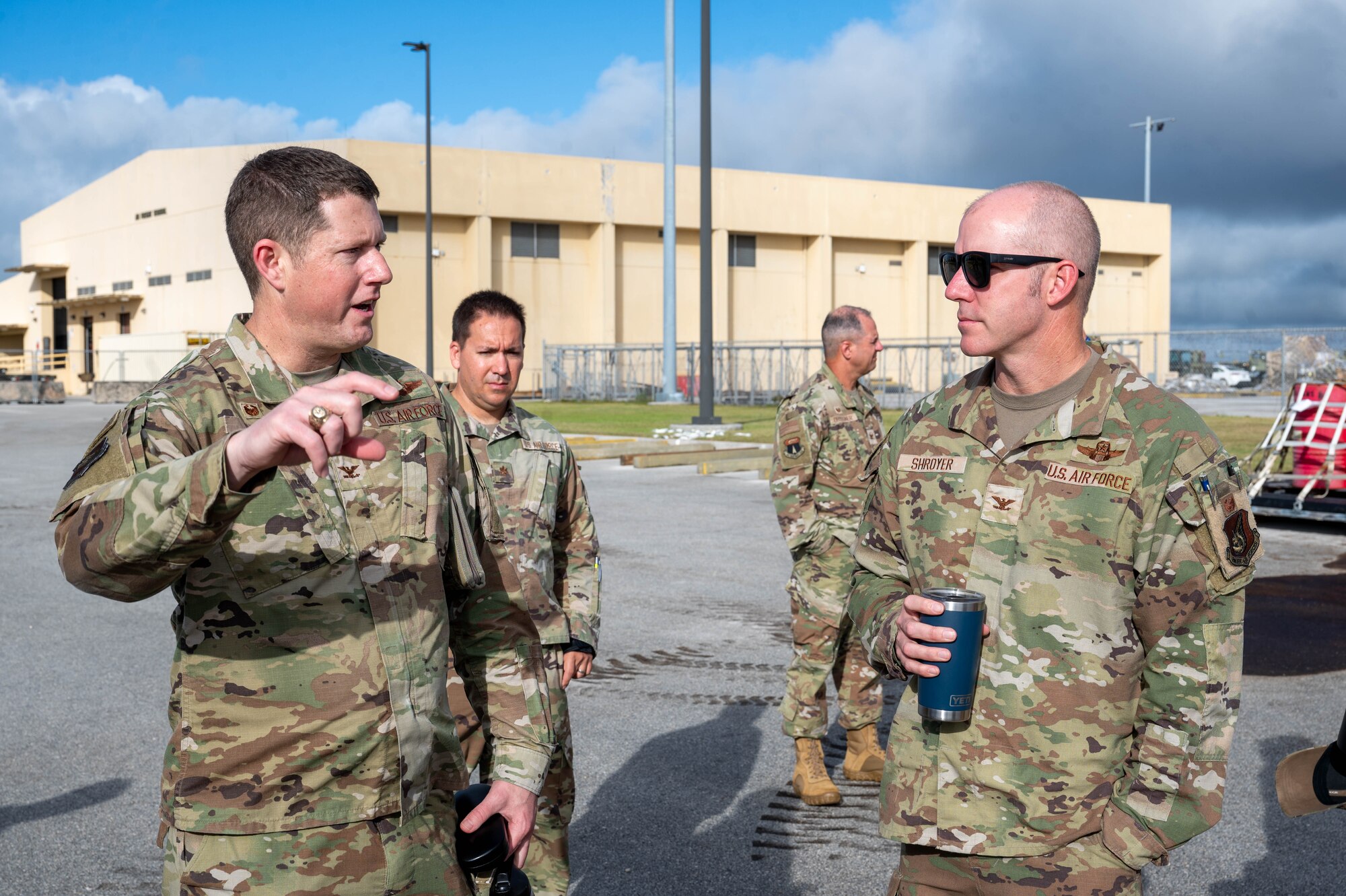 U.S. Air Force Col. Troy Pierce, commander of the 715th Air Mobility Operations Group, briefs U.S. Air Force Col. Brandon Shroyer, deputy commander of the 36th Wing, on what a Joint Inspection entails and its’ role in the cargo flow process on Andersen Air Force Base, Guam, Feb. 10, 2025. The Joint Inspection Demo held by the 734th AMS team includes an example of a correctly built cargo pallet and a cargo pallet with discrepancies from past exercises found during typical processing. (U.S. Air Force Photo by Airman 1st Class Allon Lapaix)