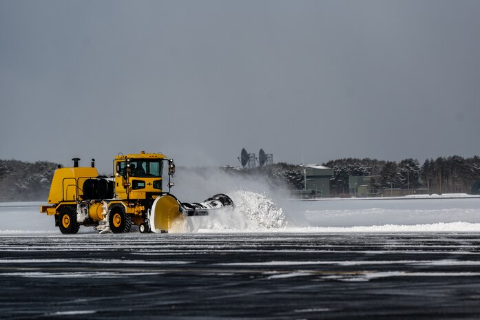 Snowplow removes snow from the flightline