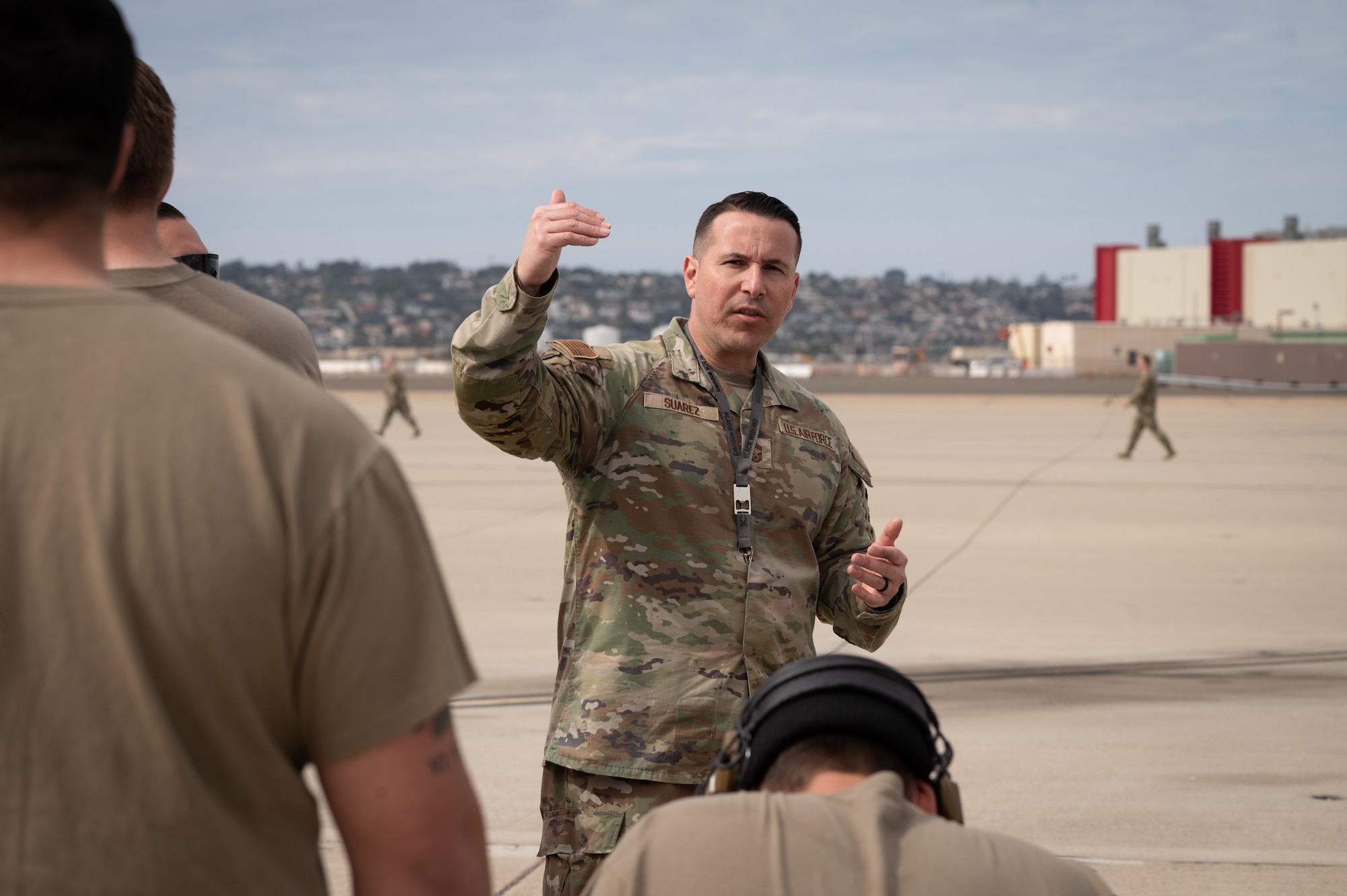 A photo of a military member talking with a group