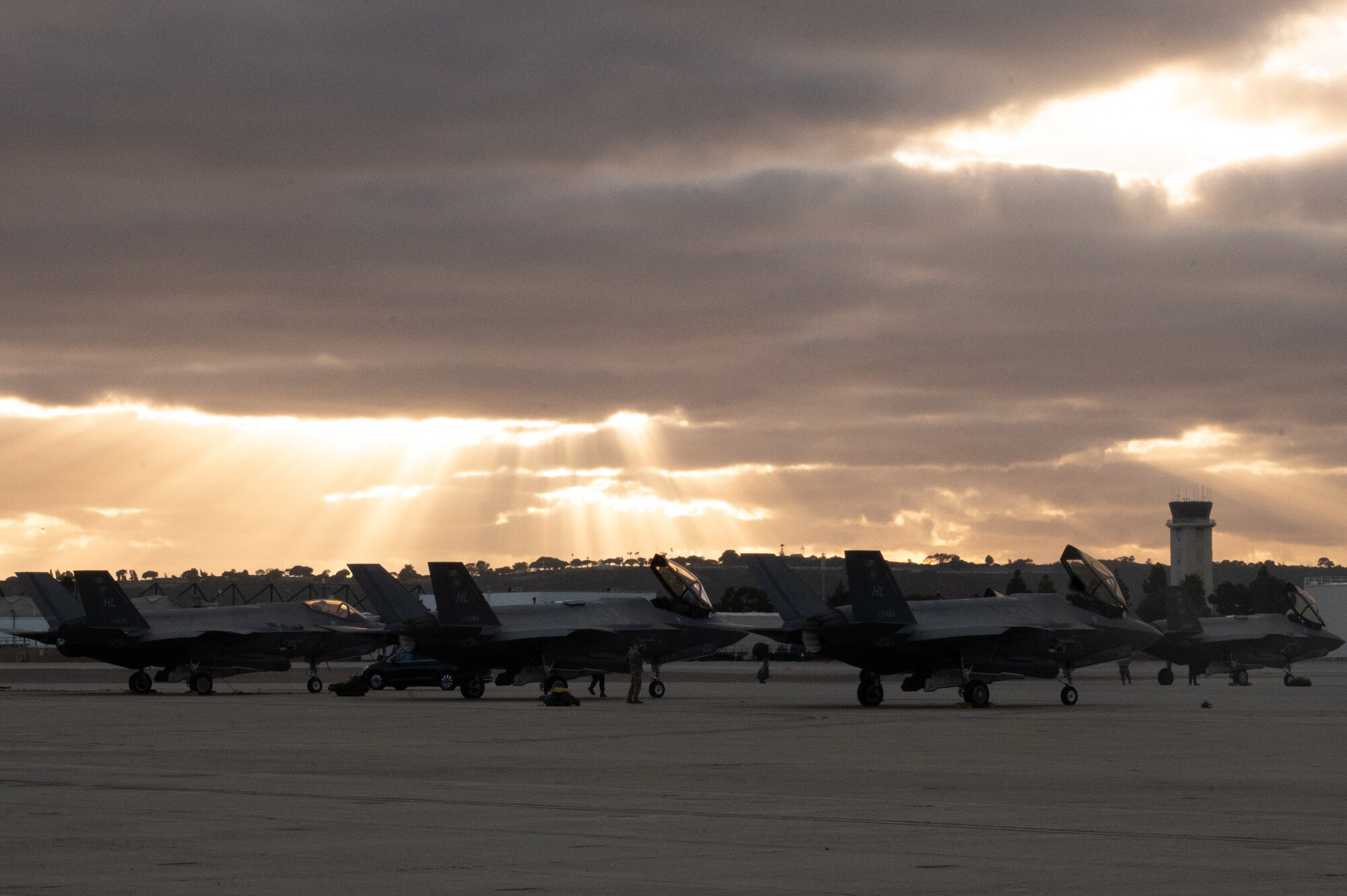 A photo of F-35A Lightning II aircraft on the flightline at sunset