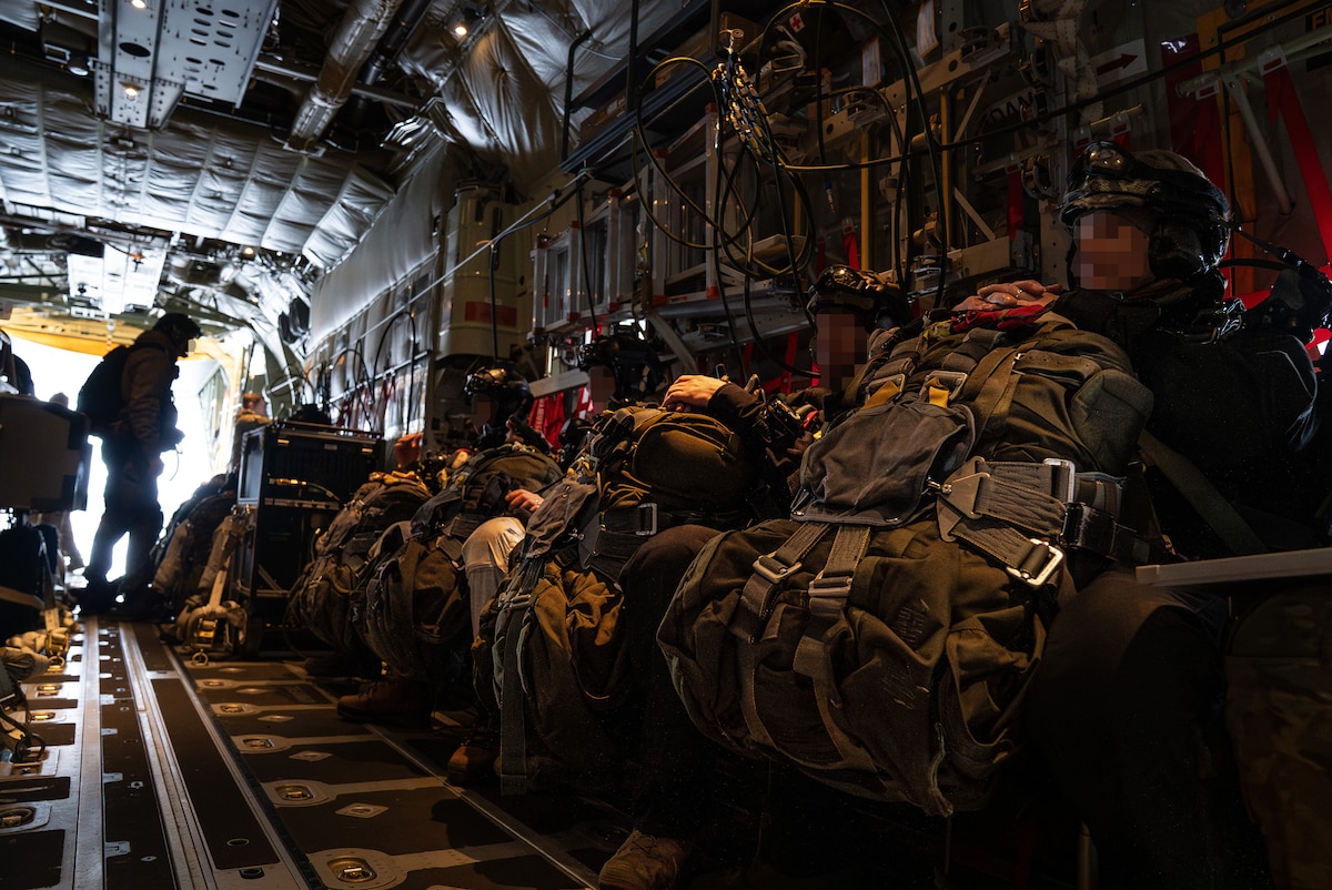 Service members sitting in a plane.