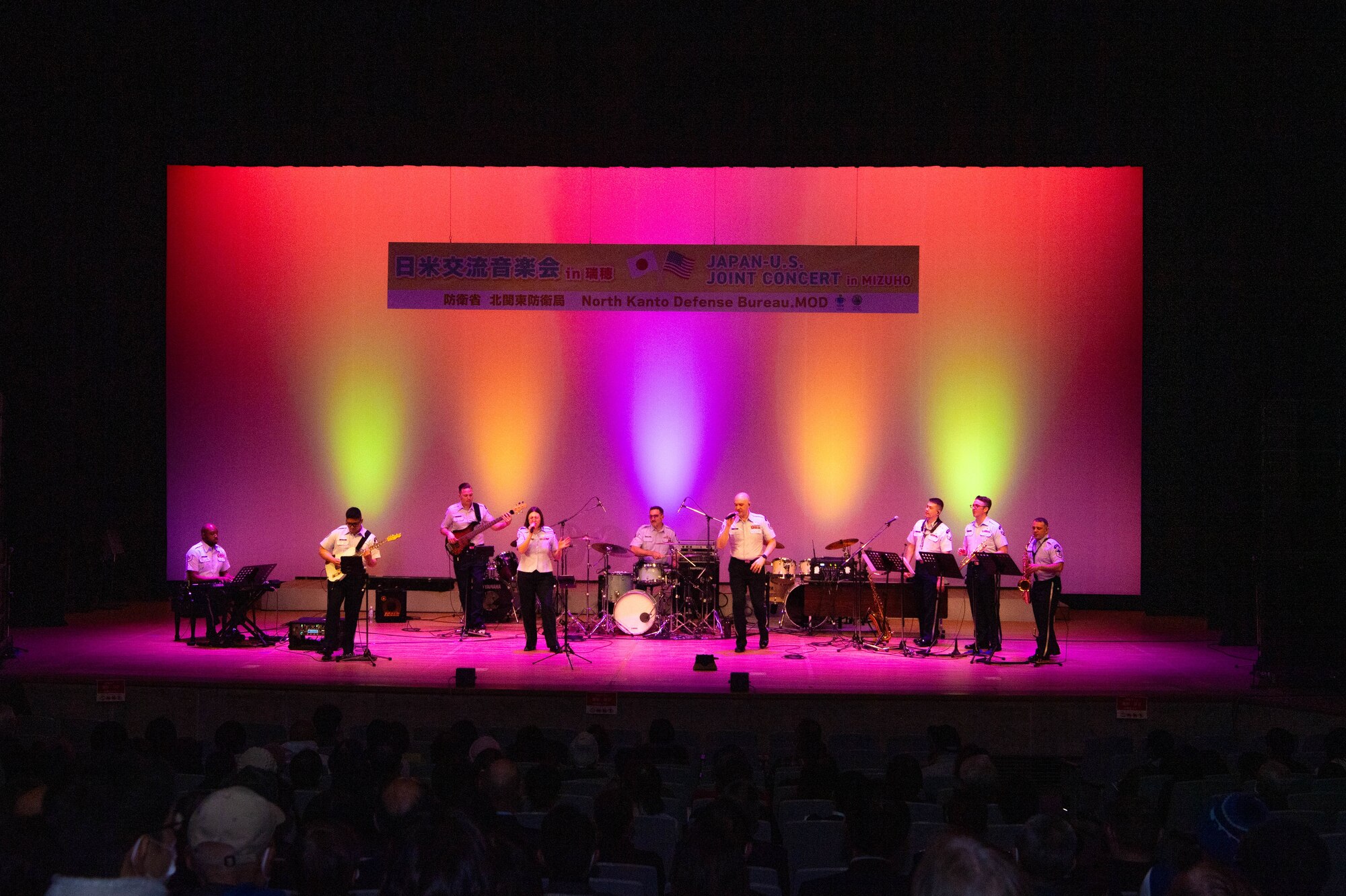 A group of people perform in a concert.