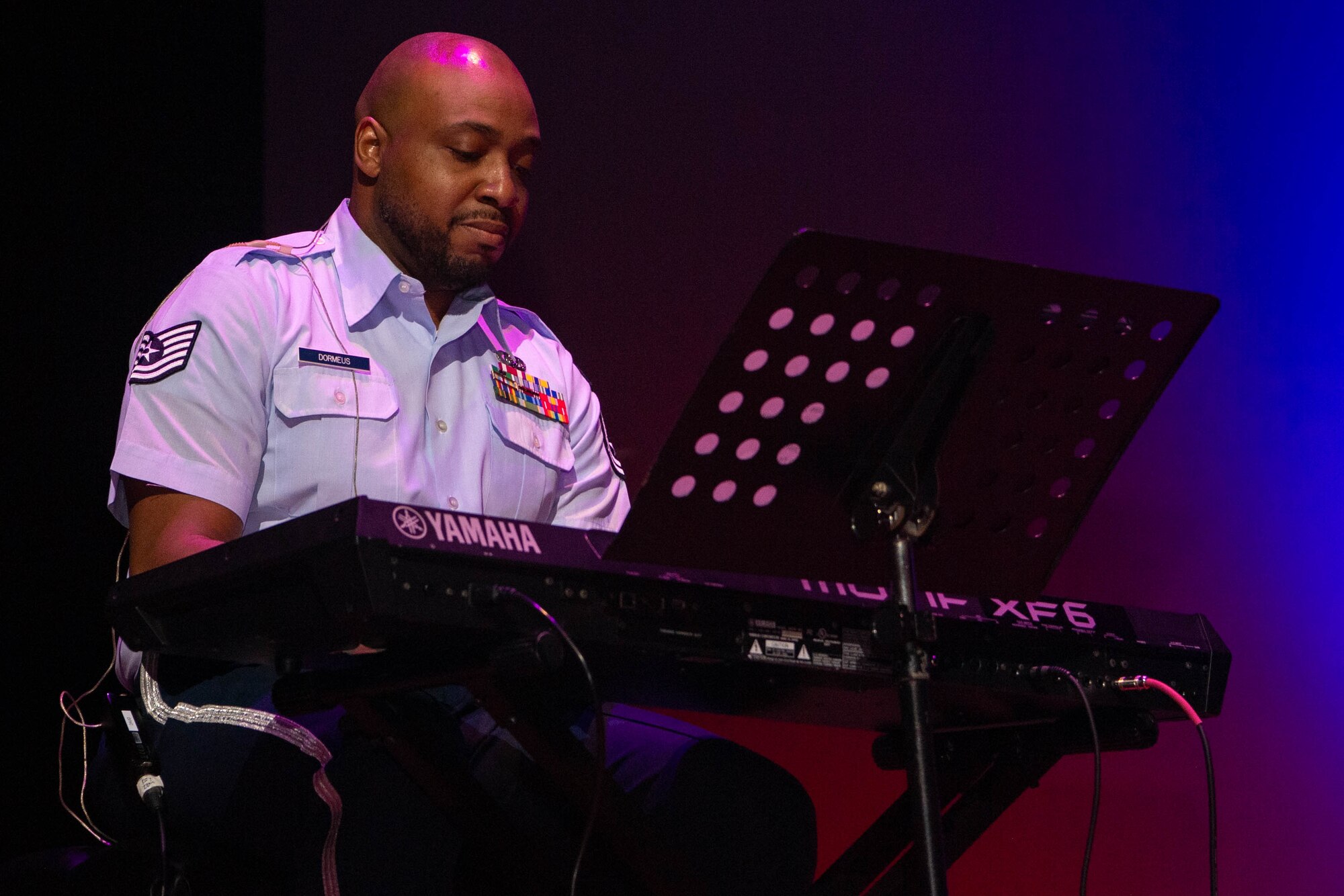 A person performs on a piano.