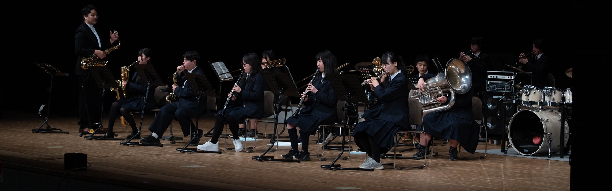 A group of people perform in a concert.