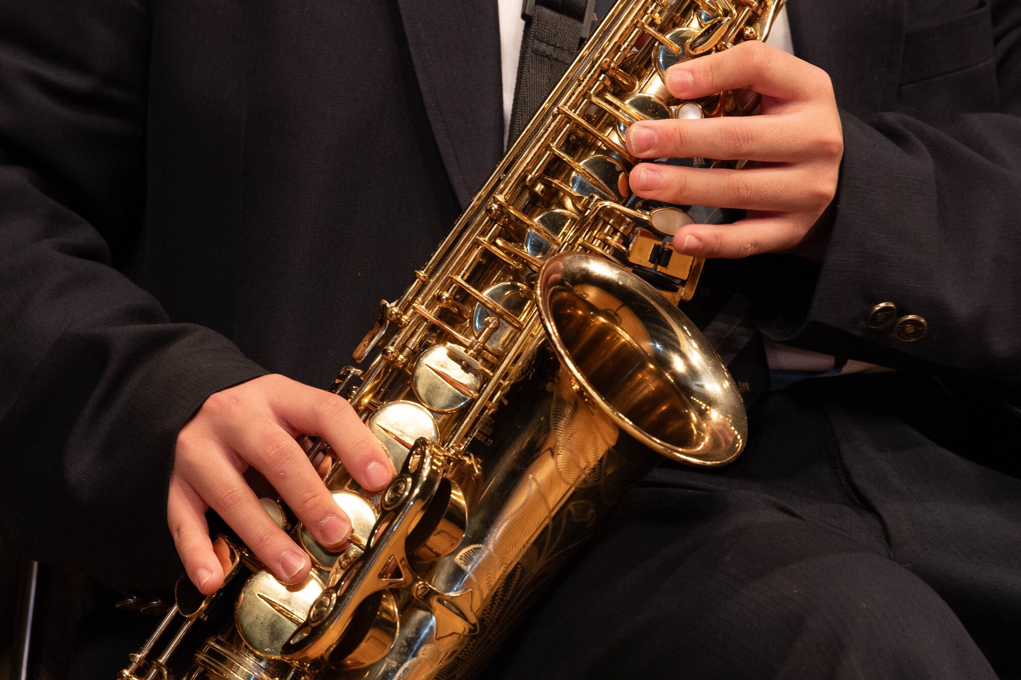 A person plays the saxophone.