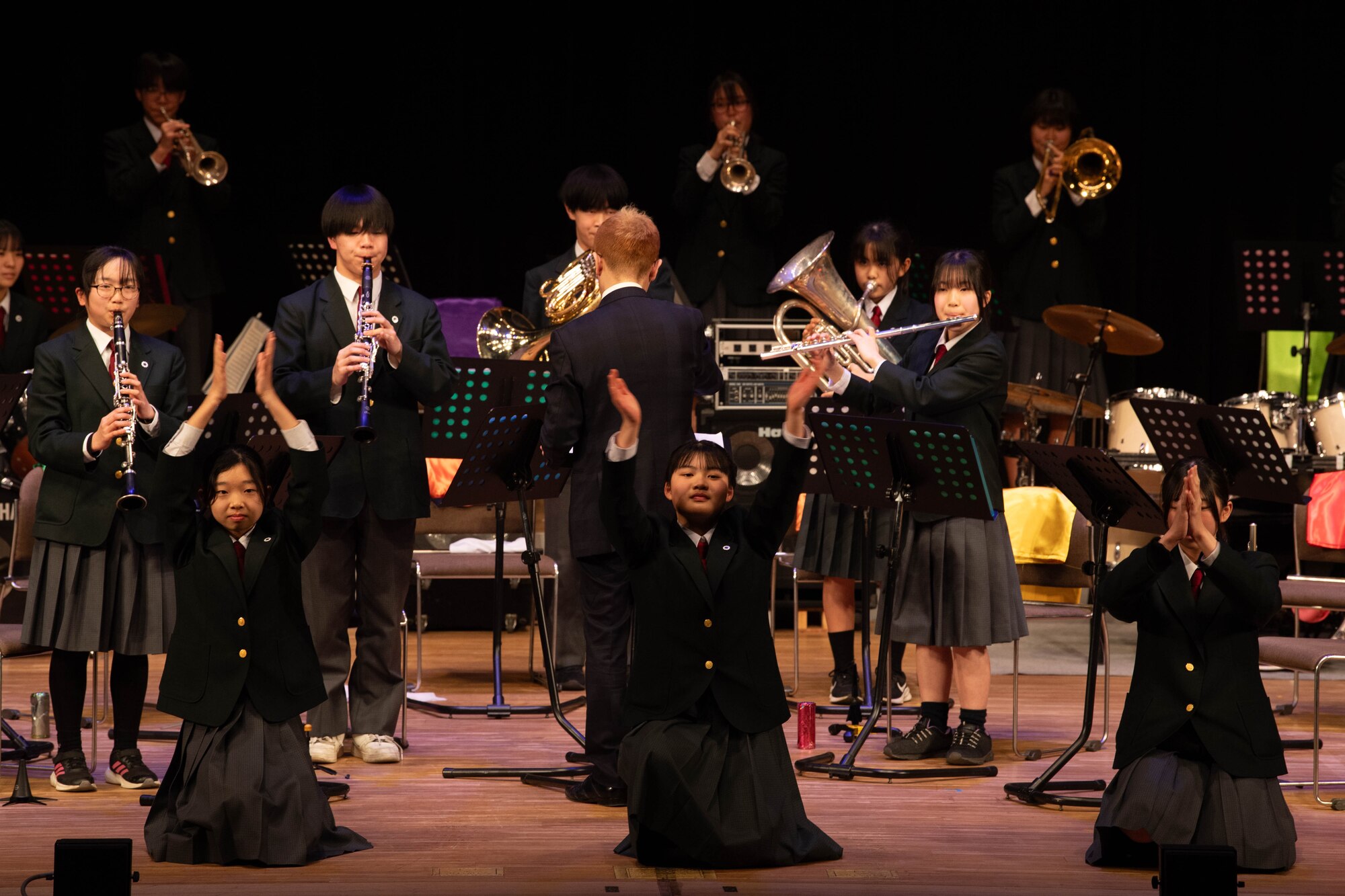 A group of people perform in a concert.