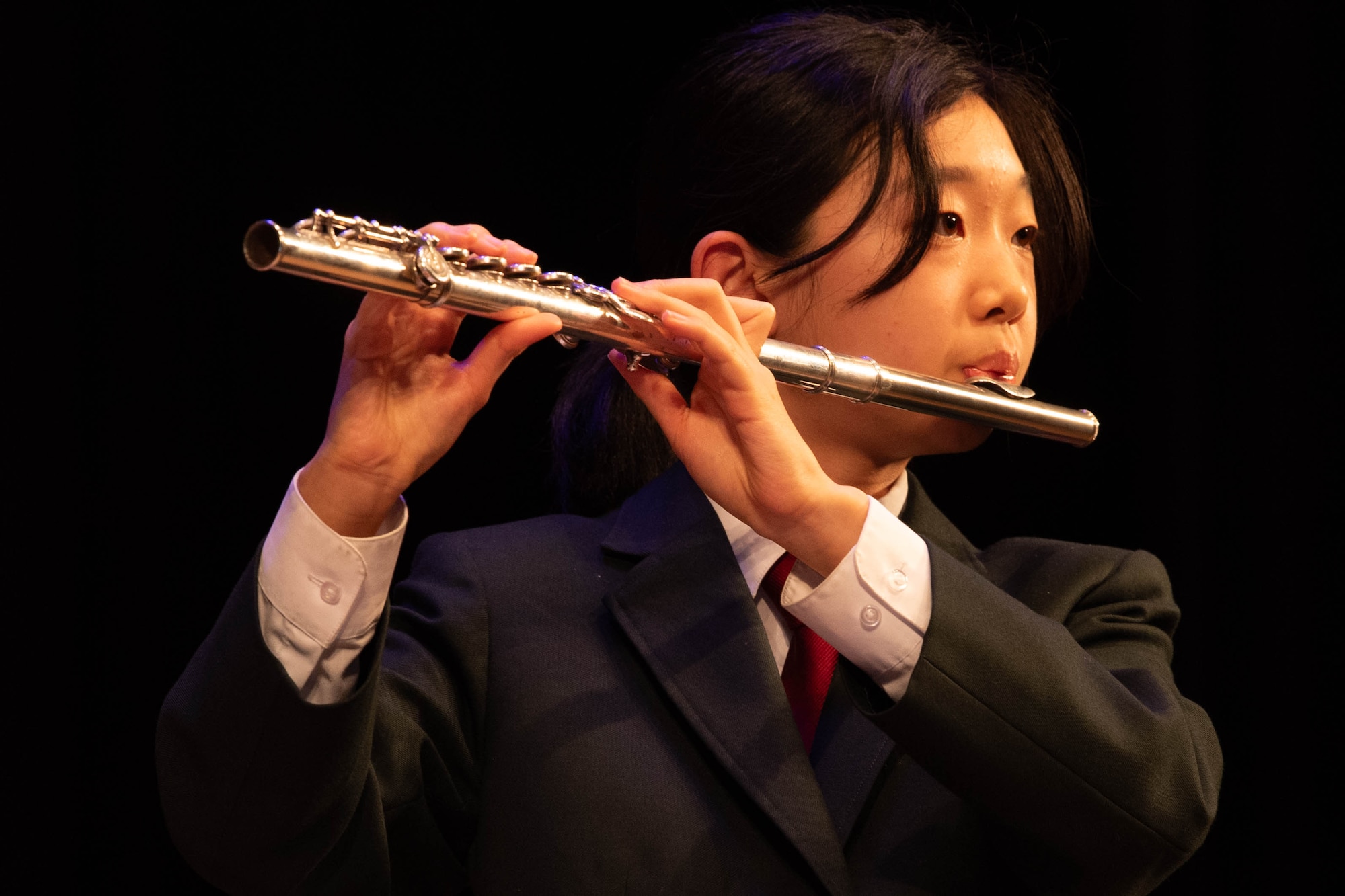 A person plays the flute.