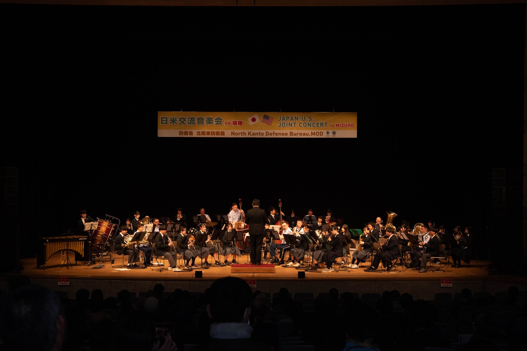 A group of people perform in a concert.