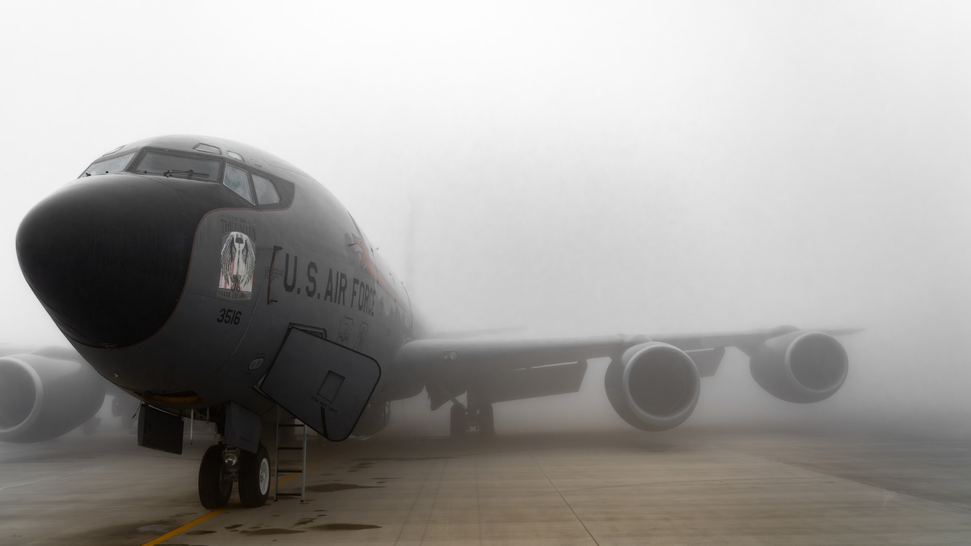 An aircraft sits in the fog