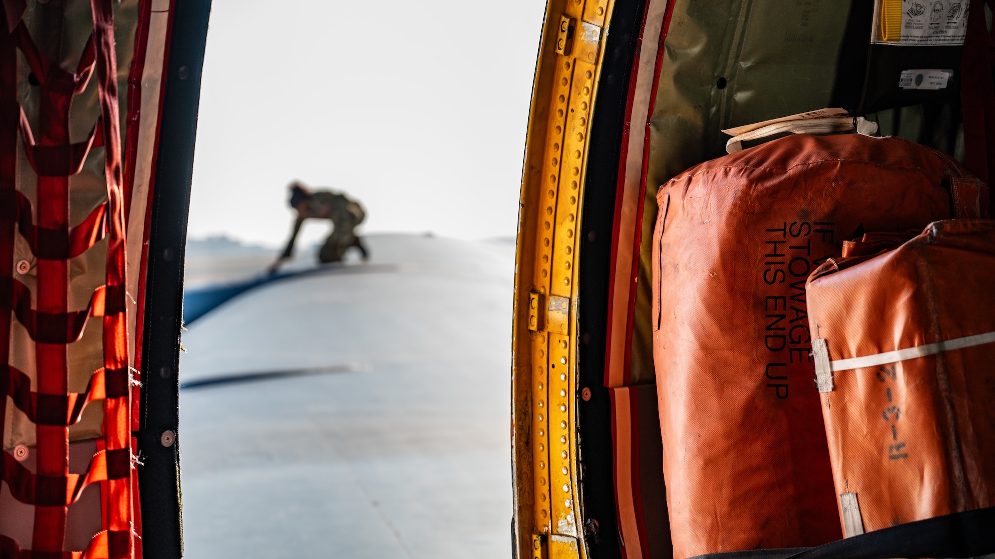 An Airman inspects the wing of an aircraft
