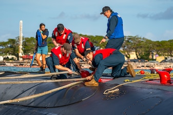 Sailors aboard USS Jefferson City (SSN 759) conduct mooring operations at Naval Base Guam.