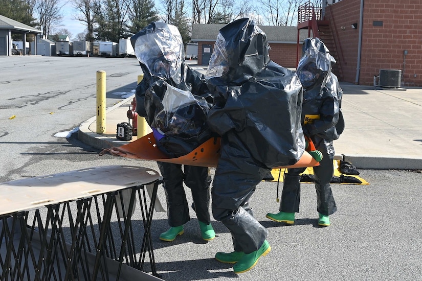 Members of the Pennsylvania National Guard’s 3rd Weapons of Mass Destruction Civil Support Team lift a team member who simulated a medical emergency onto a decontamination rack during a training exercise Feb. 7, 2025, at the Lancaster County Public Safety Training Center in Landisville, Pa. (Pennsylvania National Guard photo by Brad Rhen)