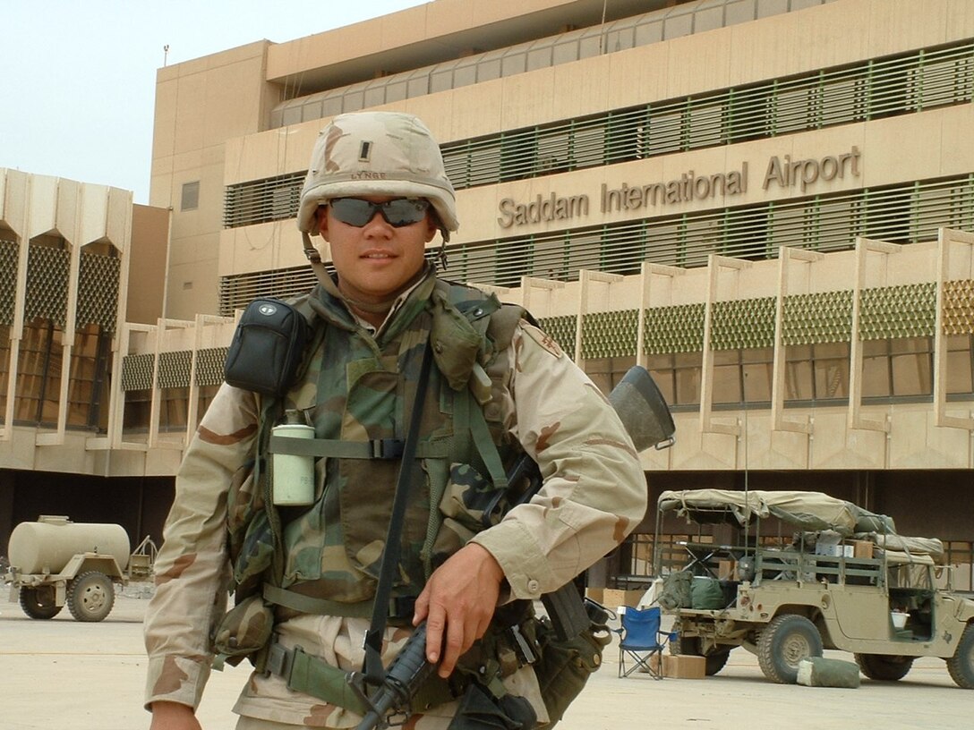 1st Lt. Christopher Lynge stands outside Saddam International Airport in Iraq during his 2003 deployment as part of the 352nd CACOM’s public health team.  Having served in the Army since 1989, Lynge has returned to the 352nd CACOM to assist them with an upcoming deployment. (Courtesy photo by US Army Lt. Col. Christopher Lynge).