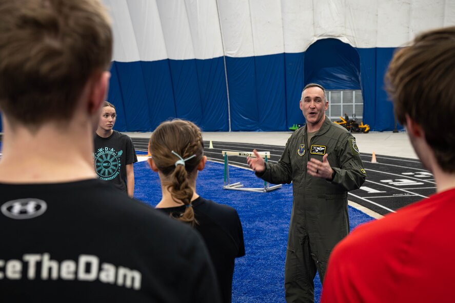 U.S. Air Force Col. Jesse Lamarand, 5th Bomb Wing commander, speaks to Minot State University track and field athletes and coaches during their practice in The Bubble at Minot Air Force Base, North Dakota, Feb. 11, 2025. Lamarand spoke about the longstanding community partnership between Minot State University and Minot AFB. (U.S. Air Force photo by Senior Airman Kyle Wilson)