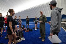 U.S. Air Force Col. Jesse Lamarand, 5th Bomb Wing commander, speaks to Minot State University track and field athletes and coaches during their practice in The Bubble at Minot Air Force Base, North Dakota, Feb. 11, 2025. Lamarand spoke about the longstanding community partnership between Minot State University and Minot AFB. (U.S. Air Force photo by Senior Airman Kyle Wilson)