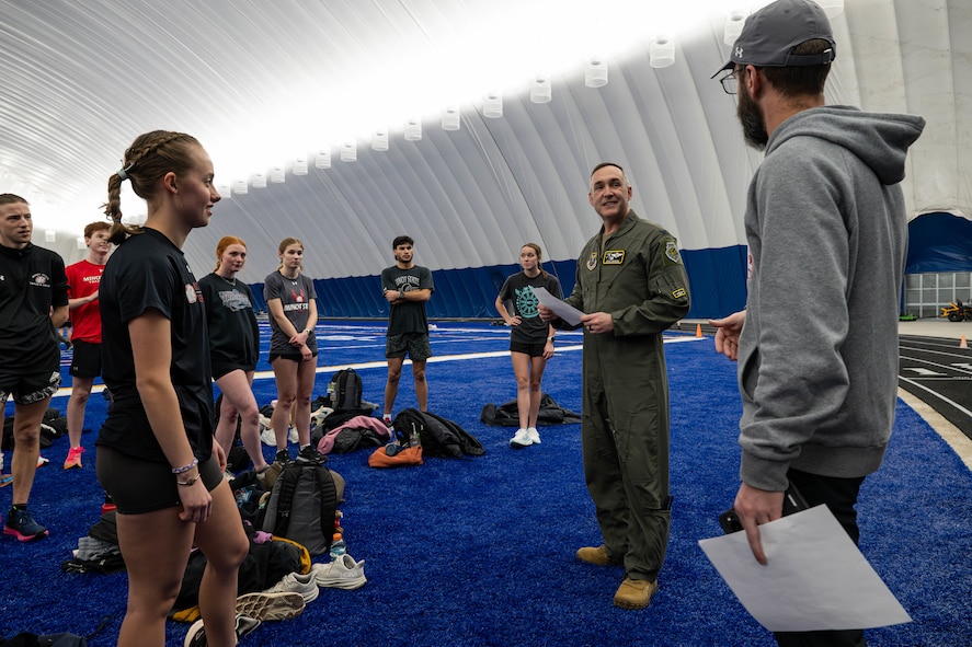 U.S. Air Force Col. Jesse Lamarand, 5th Bomb Wing commander, speaks to Minot State University track and field athletes and coaches during their practice in The Bubble at Minot Air Force Base, North Dakota, Feb. 11, 2025. Lamarand spoke about the longstanding community partnership between Minot State University and Minot AFB. (U.S. Air Force photo by Senior Airman Kyle Wilson)