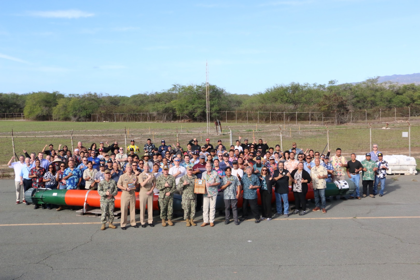 The staff of Pearl Harbor Torpedo Intermediate Maintenance Facility (PH IMA) pose for a group photo with Navy leadership after winning the inaugural Lockwood Award for Excellence in Torpedo Maintenance.