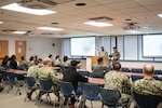 Hospital Corpsman First Class Michael Barros, center right, shares his application and acceptance experience into the U.S. Navy’s Medical Service Corps Inservice Procurement Program to fellow Sailors during a Commissioning Lunch and Learn held February 13, 2025 aboard Naval Health Clinic Cherry Point.  The mentorship session provided information to clinic Sailors about commissioning opportunities.