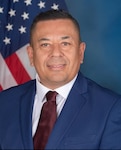 A man poses for an official portrait.