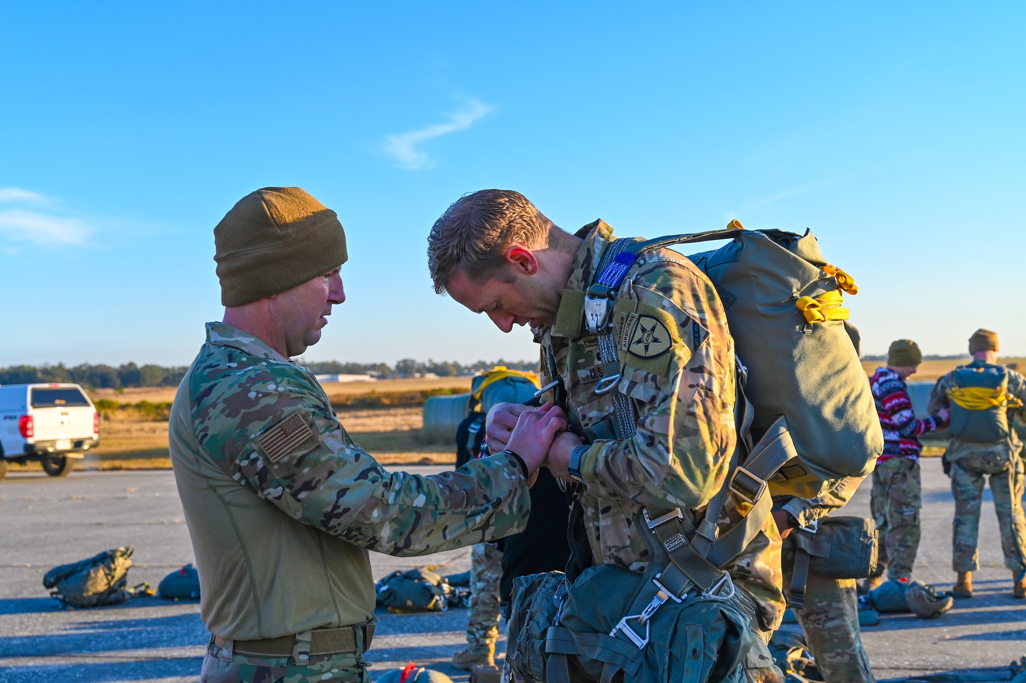U.S. Air Force Lt. Col. Paul Martin, commander of the 290th Joint Communications Support Squadron, conducts a parachute equipment check on U.S. Army Lt. Col. Mark Saurer, commander of the Joint Communications Support Element, 2nd Squadron, prior to a static-line training jump at Brooksville Airfield, Florida, Dec. 5, 2024.
