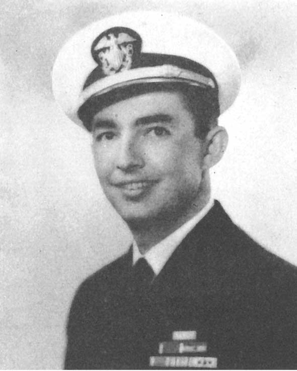 A man in cap and uniform poses for a photo.