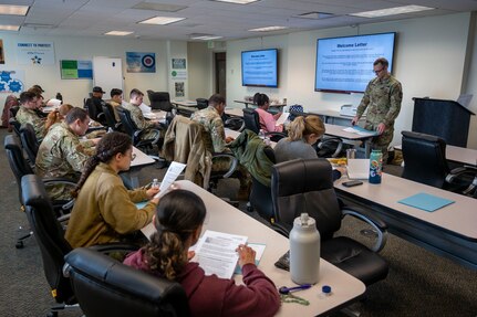 Major Osgood, Deputy Director of the Walter Reed Army Institute of Research – West, goes over the welcome letter with the Air Force trainees at peer ambassador training. 

(Photo taken by 62nd Airlift Wing Public Affairs)
