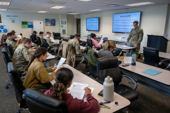 Major Osgood, Deputy Director of the Walter Reed Army Institute of Research – West, goes over the welcome letter with the Air Force trainees at peer ambassador training. 

(Photo taken by 62nd Airlift Wing Public Affairs)