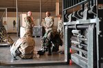 Chief Master Sgt. Israel Nuñez, Senior Enlisted Advisor to the Chief of Air Force Reserve and Command Chief Master Sgt. of Air Force Reserve Command, observes as aerial port Airmen conduct chemical warfare training at Joint Base San Antonio-Lackland, Feb. 1, 2025.