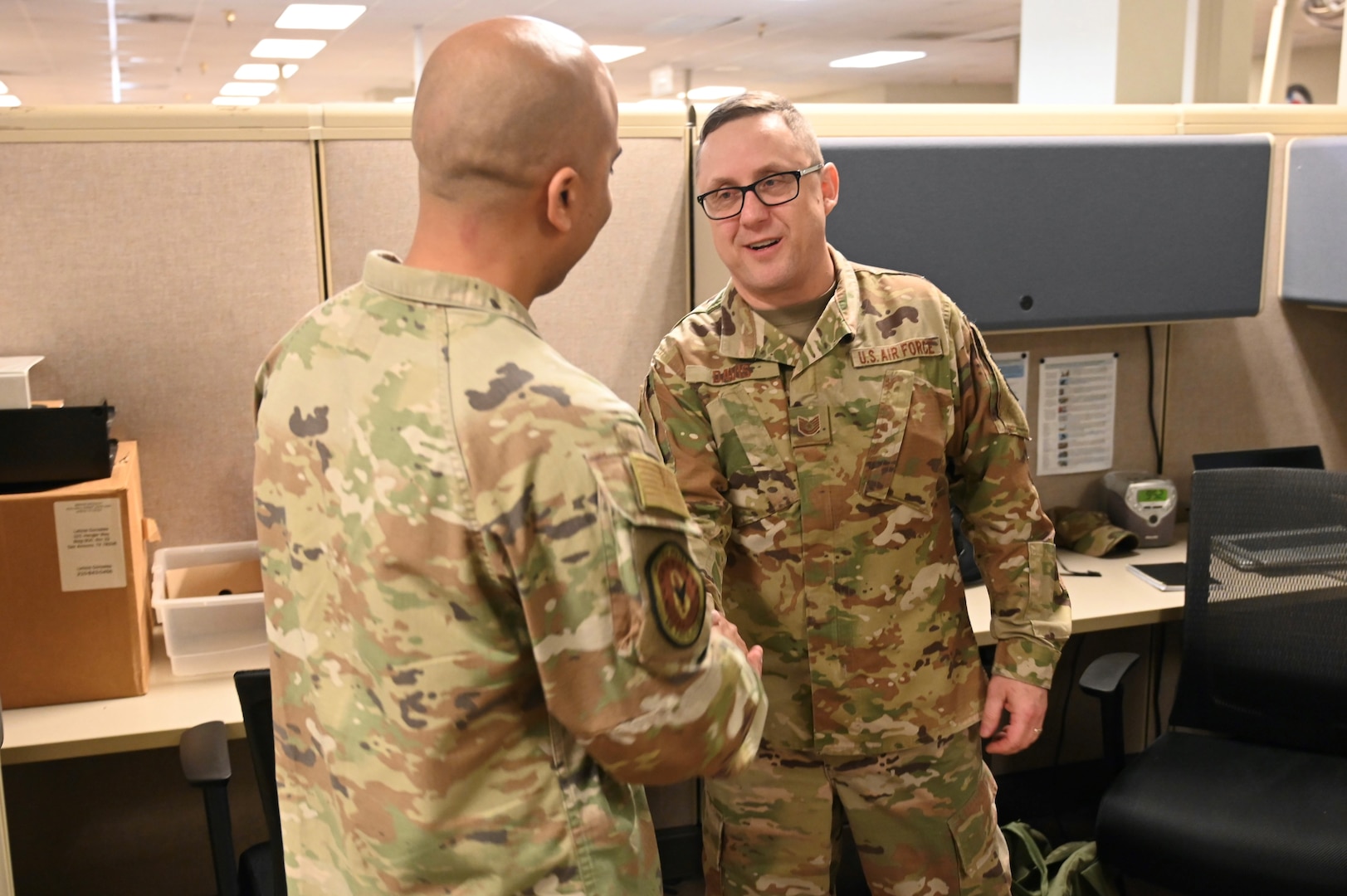 Technical Sgt. Christopher Davis, 26th Aerial Port Squadron unit deployment manager, receives a coin from Chief Master Sgt. Israel Nuñez, Senior Enlisted Advisor to the Chief of Air Force Reserve and Command Chief Master Sgt. of Air Force Reserve Command, during his visit to Joint Base San Antonio-Lackland, Feb. 1, 2025.