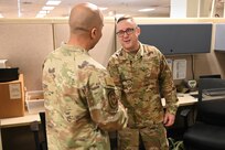 Technical Sgt. Christopher Davis, 26th Aerial Port Squadron unit deployment manager, receives a coin from Chief Master Sgt. Israel Nuñez, Senior Enlisted Advisor to the Chief of Air Force Reserve and Command Chief Master Sgt. of Air Force Reserve Command, during his visit to Joint Base San Antonio-Lackland, Feb. 1, 2025.