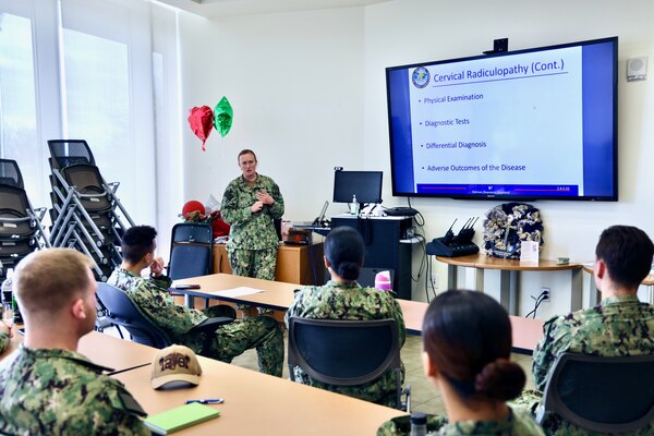 Hospital Corpsman 1st Class Courtney Smith instructs hospital corpsmen during the Sick Call Screener Course (SCSC) at Naval Medical Readiness and Training Command (NMRTC) Twentynine Palms on Feb. 12, 2025. The course, developed by NMRTC Twentynine Palms leadership, enhances medical proficiency by training corpsmen to triage and evaluate acute patients under provider supervision. By implementing the SCSC, the Adult Medical Care Clinic (AMCC) has significantly improved access to care, reducing appointment wait times from six weeks to seven days and ensuring Marines receive timely medical attention to maintain operational readiness (U.S. Navy photo by Christopher C. Jones, NHTP/NMRTC Twentynine Palms public affairs officer).
