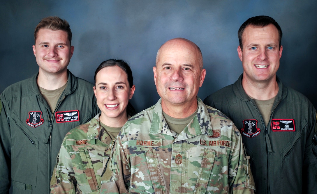 Nebraska Air National Guard Chief Master Sgt. Jeffrey Horne, Nebraska Air National Guard state command chief master sergeant, poses for a photograph with three of his children who have chosen to follow his footsteps and join the Nebraska Air National Guard. Pictured are, from left, Senior Airman Hunter Horne, who serves as an aerial boom operator within the 155th Air Refueling Wing, 1st Lt. Madison Horne, who serves as a maintenance officer in the 155th Air Refueling Wing, and Capt. Dillon Horne, who serves as a KC-135R Stratotanker pilot in the 155th Air Refueling Wing. Horne recently retired after a 40 year military career with the Nebraska Air National Guard. (Photo by Kevin Hynes)