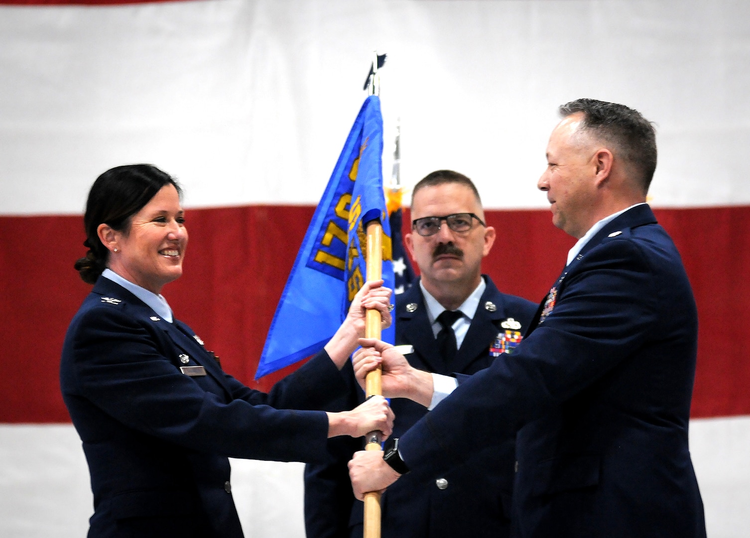 Nebraska Air National Guard Lt. Col. Samuel Schneider (right) relinquishes command of the Nebraska Air National Guard's 170th Maintenance Support Squadron to Col. Wendy Squarcia, commander of the 170th Group, during a change of command ceremony held Jan. 30, 2025, at Offutt Air Force Base. Schneider had served as the first commander of the new maintenance support squadron since April 2022. (Nebraska National Guard photo by Kevin Hynes).