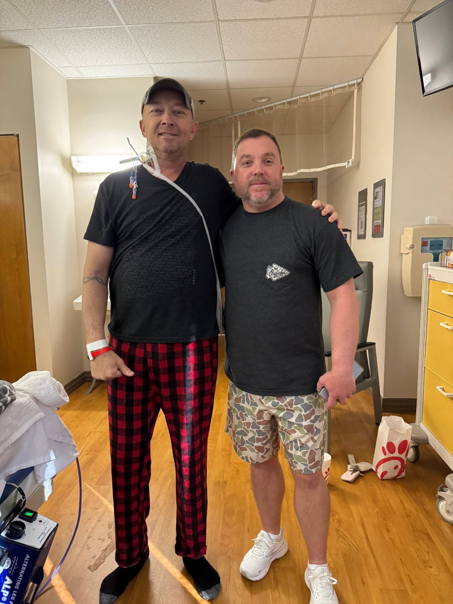 Three days post-transplant, Chief Master Sgt. Kevin Sargent (left) and Master Sgt. Ron Bohl, who donated a kidney to Sargent, share a smile at the University of Alabama at Birmingham, marking a new beginning for Sargent's health journey. Bohl, a Mississippi Air National Guardsman, donated a kidney to Sargent, an Alabama Air National Guardsman, through a paired donor program, after Bohl was found not to be a match for his brother (photo provided by Master Sgt. Ron Bohl)