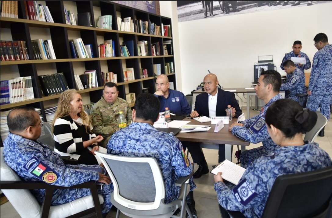 U.S. and Mexican Air Force participants sitting at a table, discussing how to strengthen their collaboration and tackle shared challenges at the 2024 Air Force Staff Talks (AFST) between the US and Mexican Air Forces.