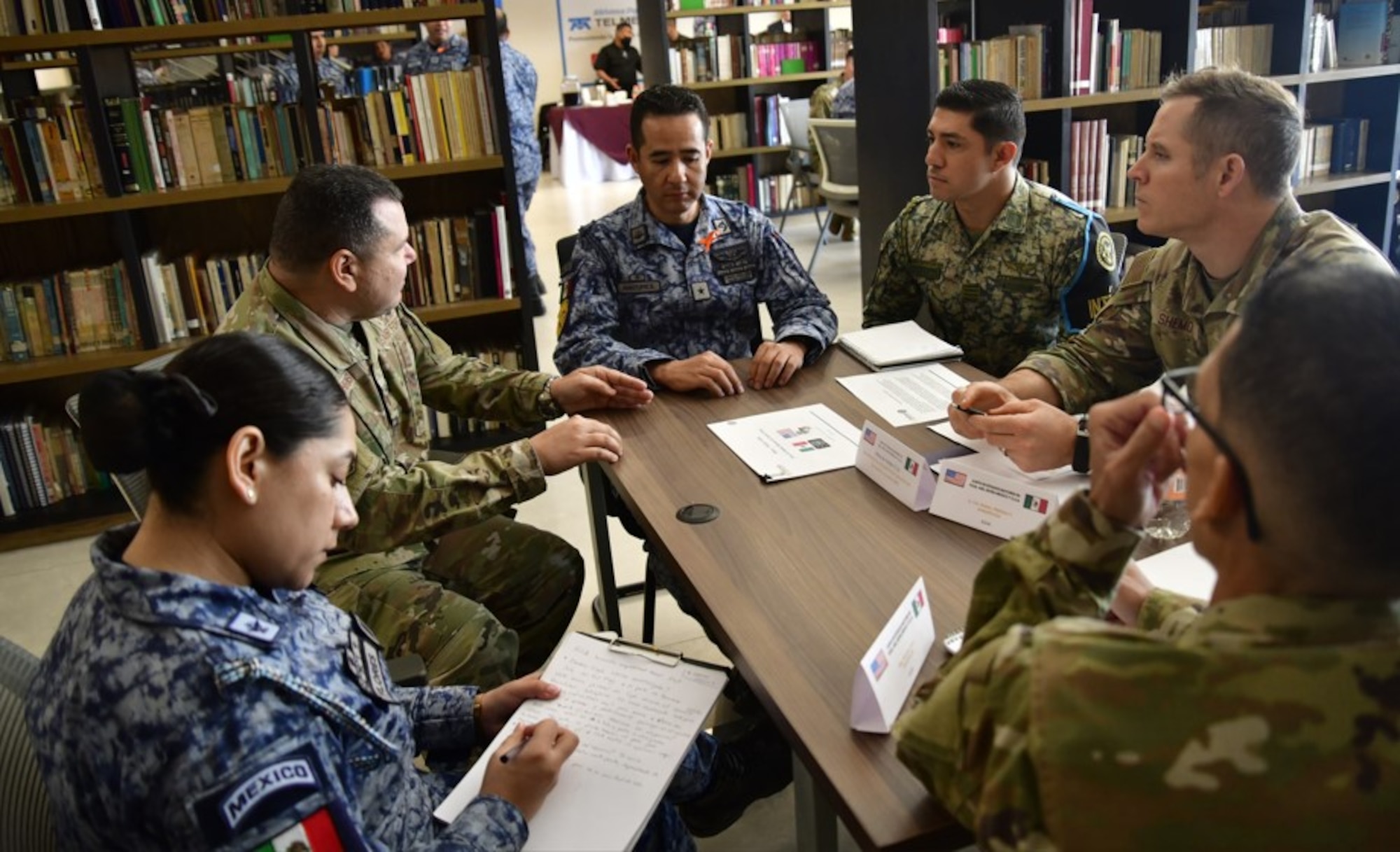 U.S. and Mexican Air Force participants sitting at a table, discussing how to strengthen their collaboration and tackle shared challenges at the 2024 Air Force Staff Talks (AFST) between the US and Mexican Air Forces.