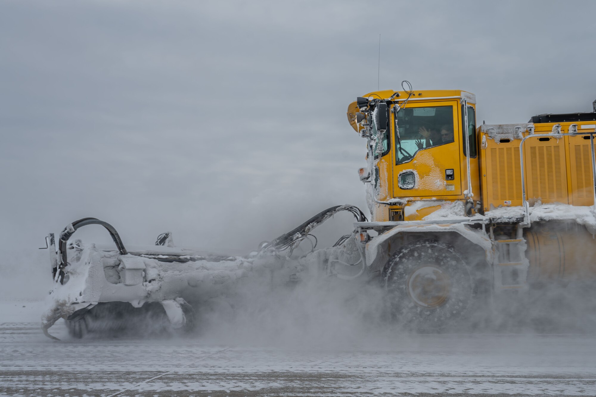 (From left) Staff Sgt. Darius Bolayog, 22nd Civil Engineer Squadron power production journeyman, and Jonathan “Geno” Giadina, 22nd CES structural maintenance mechanic, operate a snow removal vehicle at McConnell Air Force Base, Kansas, Feb. 12, 2025. The engineering equipment operators used snow plows, blowers and brooms to clear snow on base. (U.S. Air Force photo by Airman 1st Class Paula Arce)