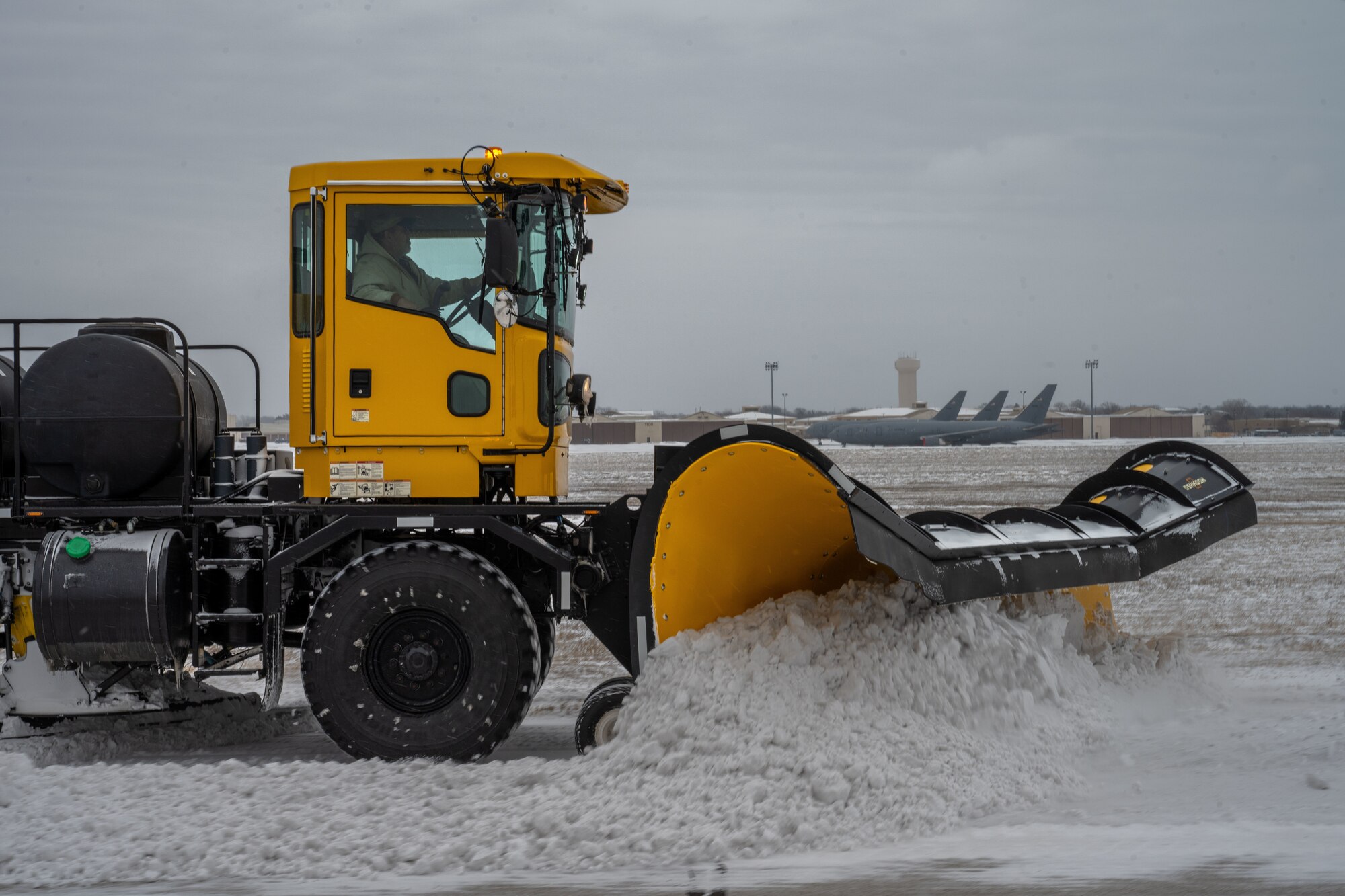Richard Dodd, 22nd Civil Engineer Squadron engineering equipment operator, drives a snow removal vehicle at McConnell Air Force Base, Kansas, Feb. 12, 2025. The engineering equipment operators strategically prioritized areas of McConnell to ensure operations returned to normal as quickly as possible. (U.S. Air Force photo by Airman 1st Class Paula Arce)