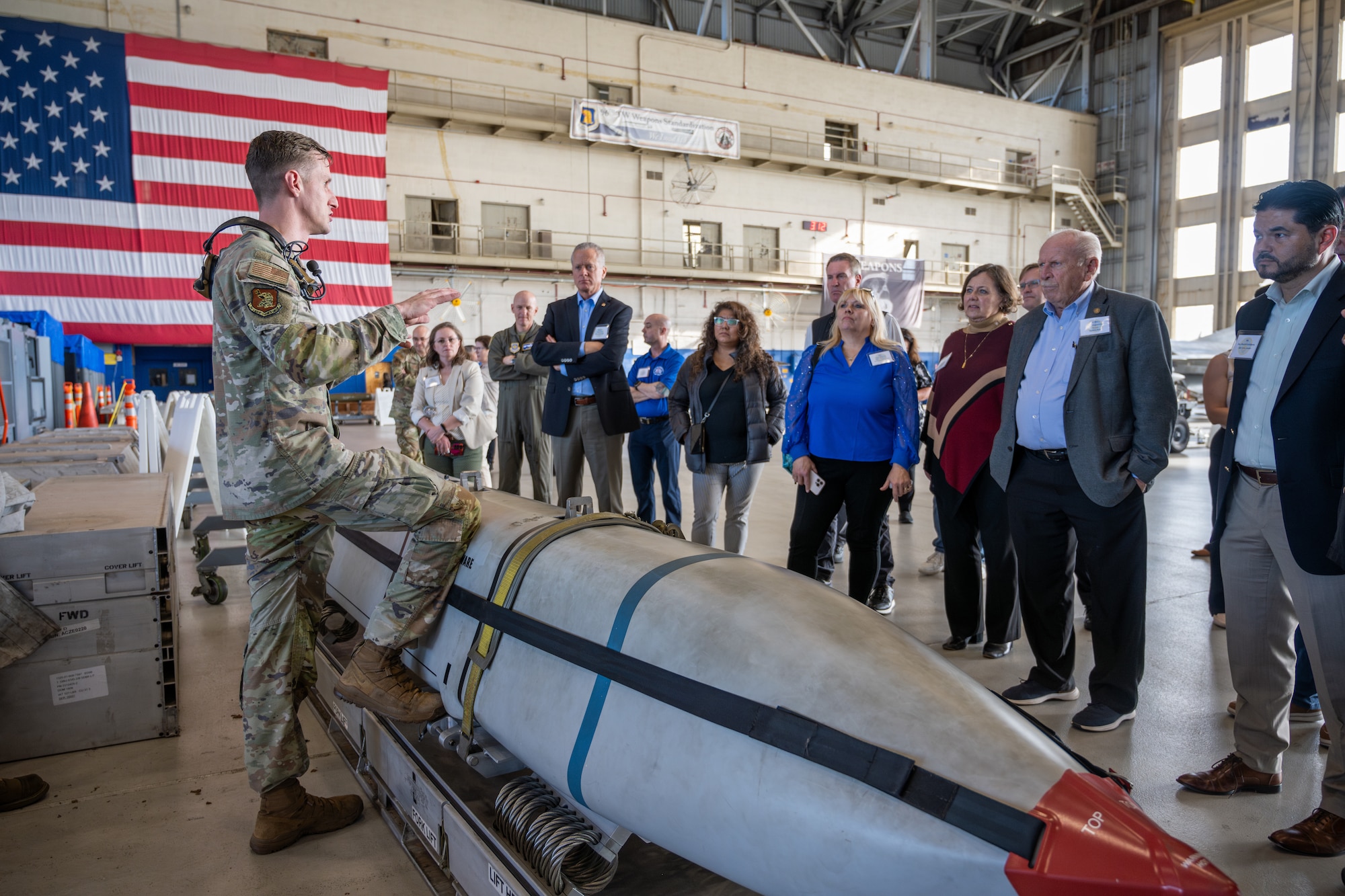 Airman briefs civic leaders inside hangar